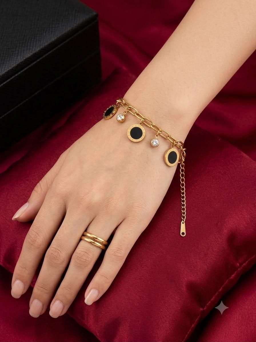 Gold charm bracelet on red silk